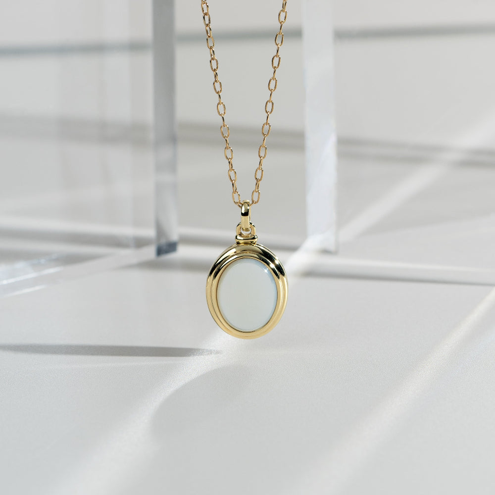 Bona Fide Mother of Pearl Oval Locket In Yellow Gold Plated Silver flatlay